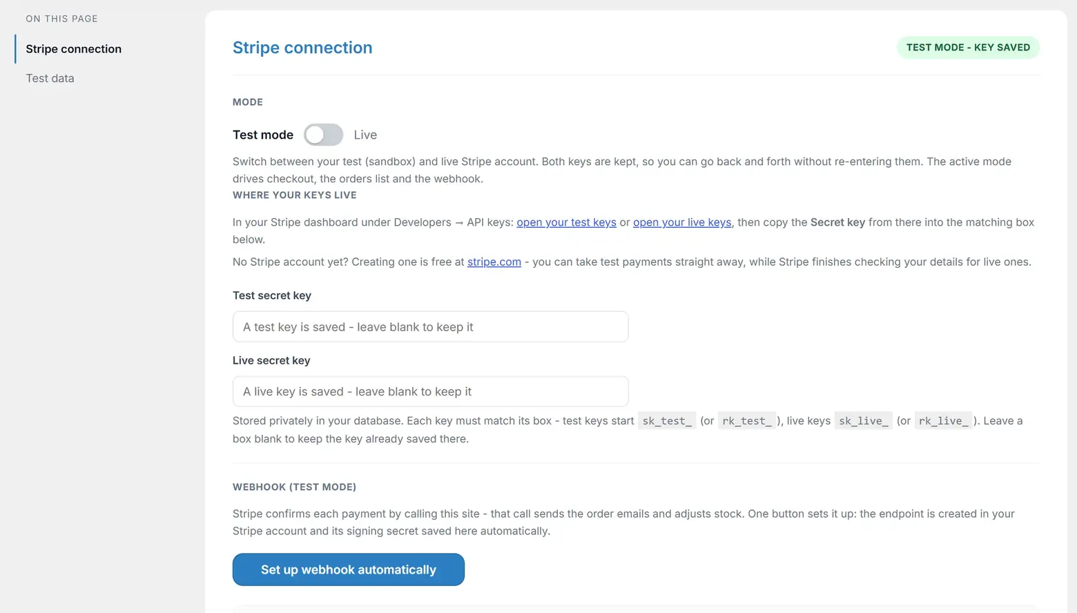 The Stripe tab: the test and live secret key boxes with a key saved, the mode switch, and the webhook section below